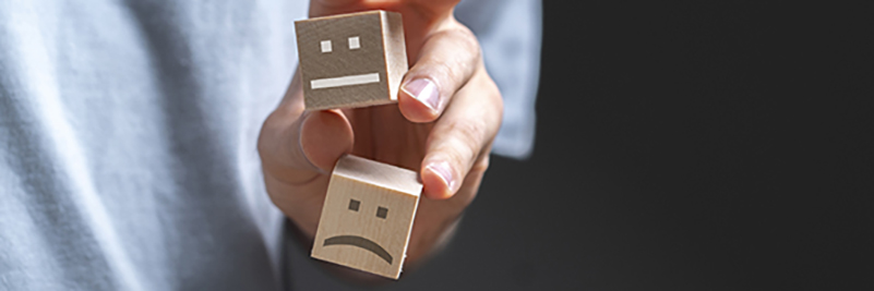 Image of a customer holding three cubes with smiles