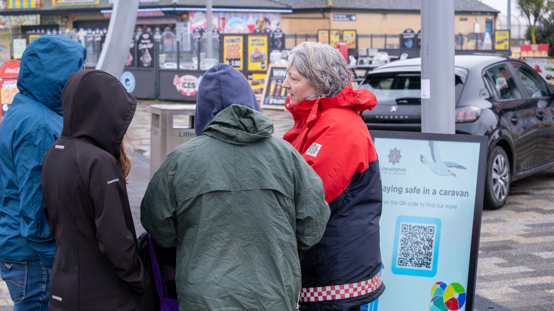 Lincolnshire Fire and Rescue community safety advocate talking to members of public in Skegness