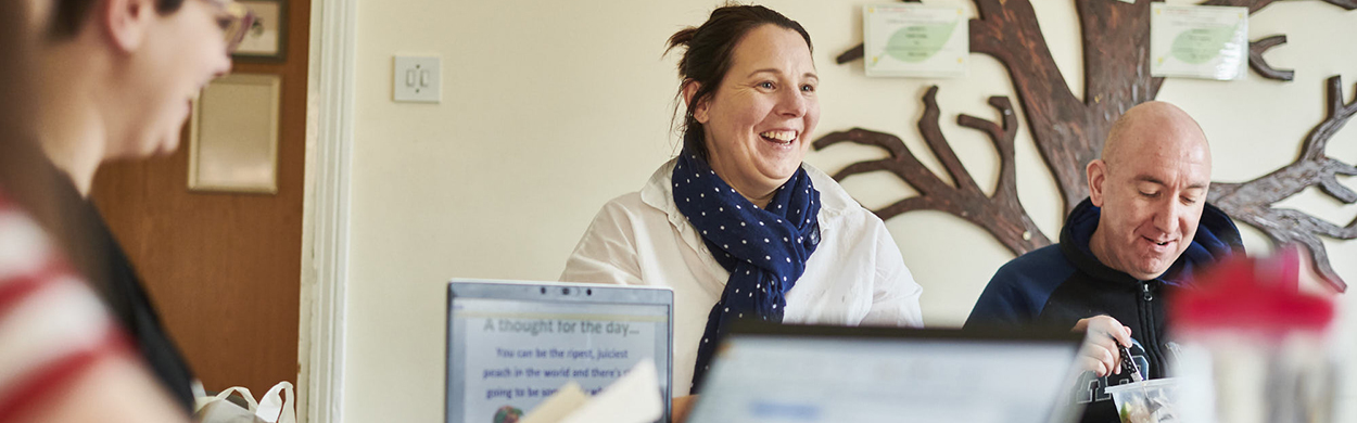 Image of woman sat at table with colleagues