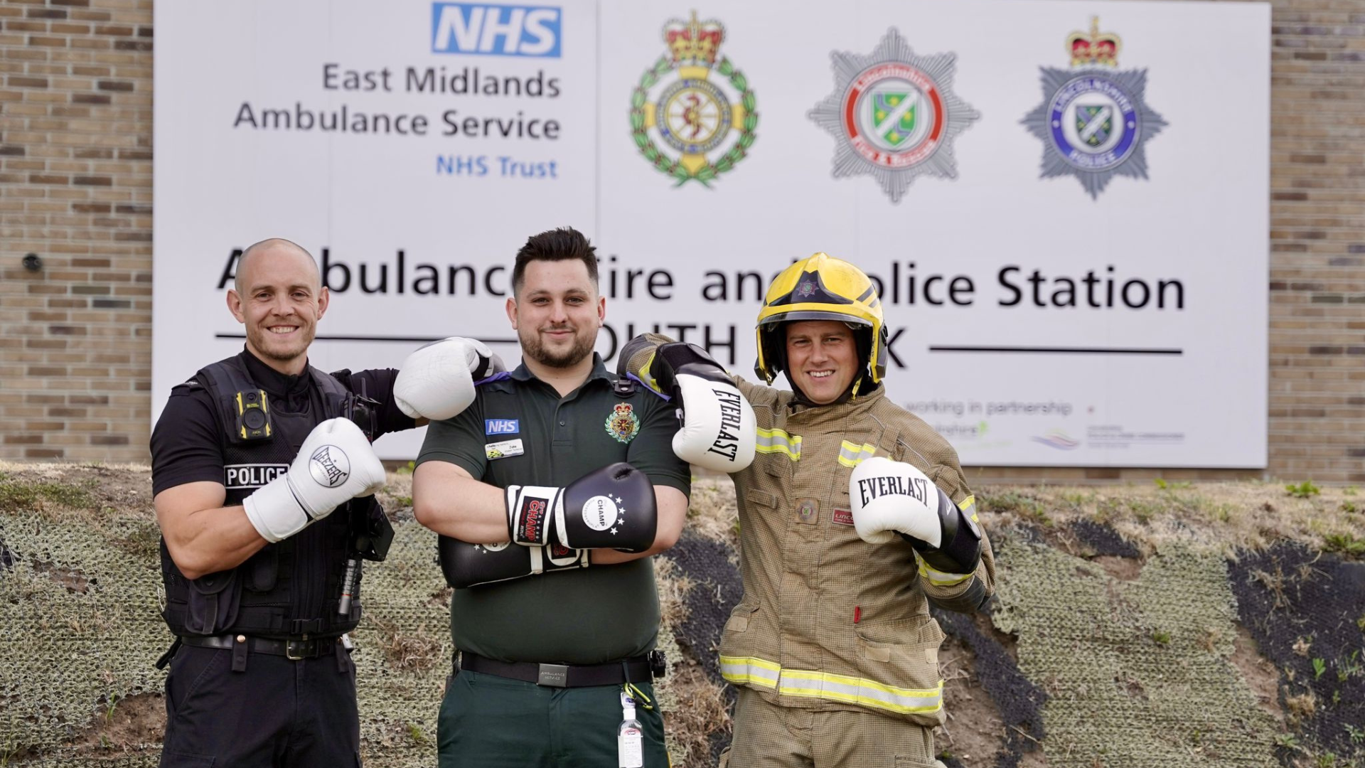Police officer, paramedic, and firefighter in boxing gloves