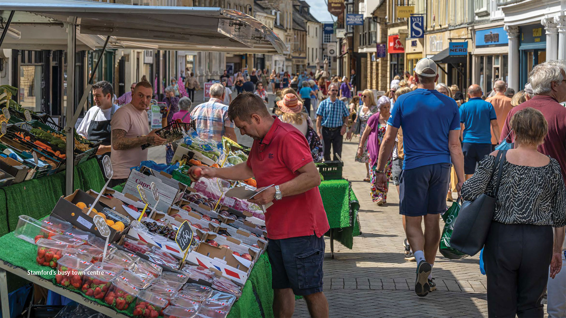 Man picking vegetables at a town market