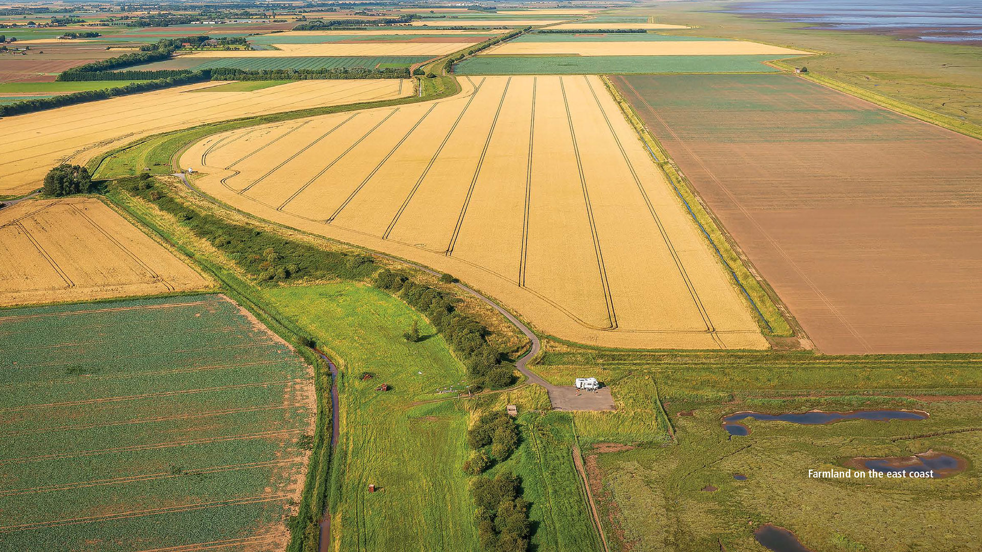 Aerial view of Lincolnshire coast line with fields and marshland