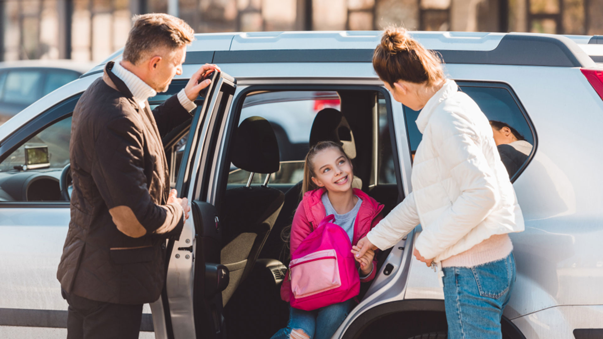 Child stepping out of car going to school