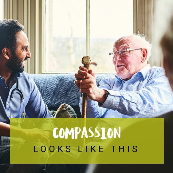 Two males talking with &#039;compassion looks like this&#039; text
