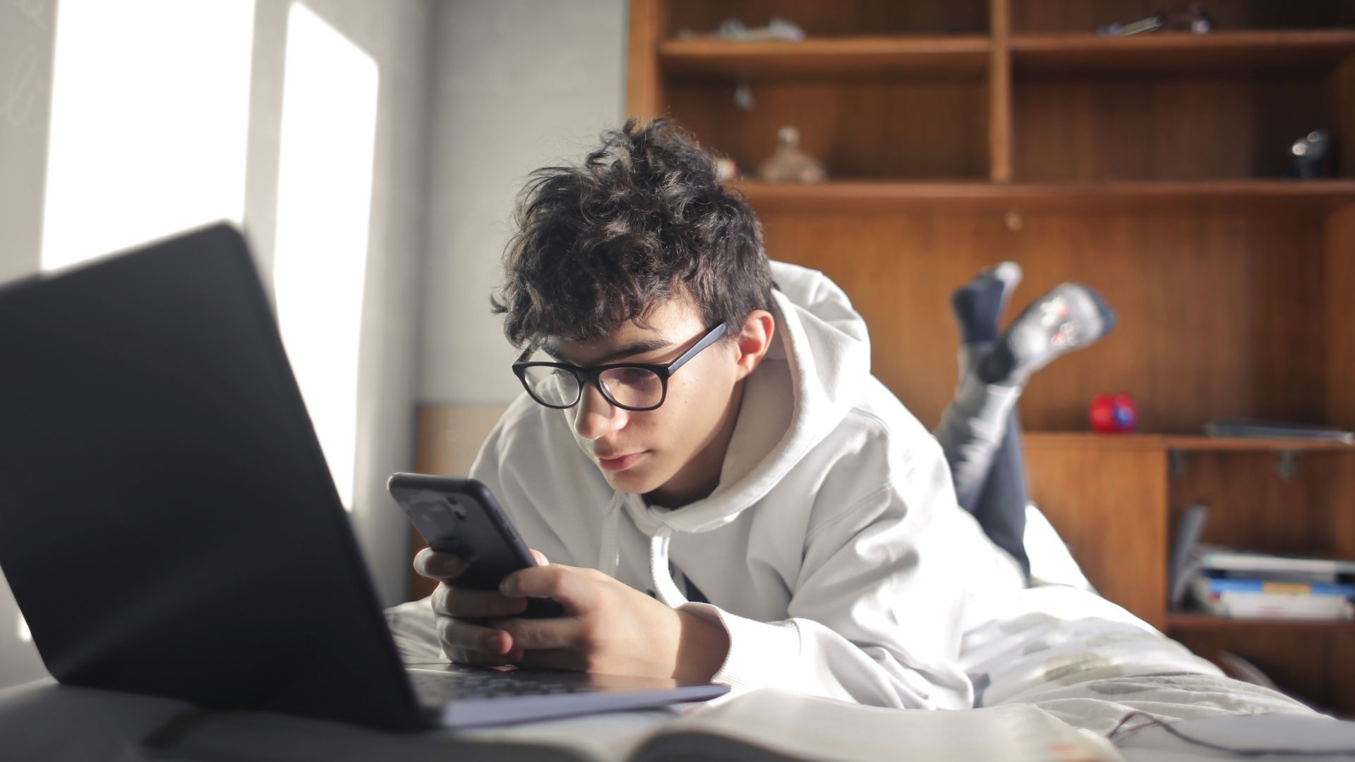 A teenage boy uses a mobile phone