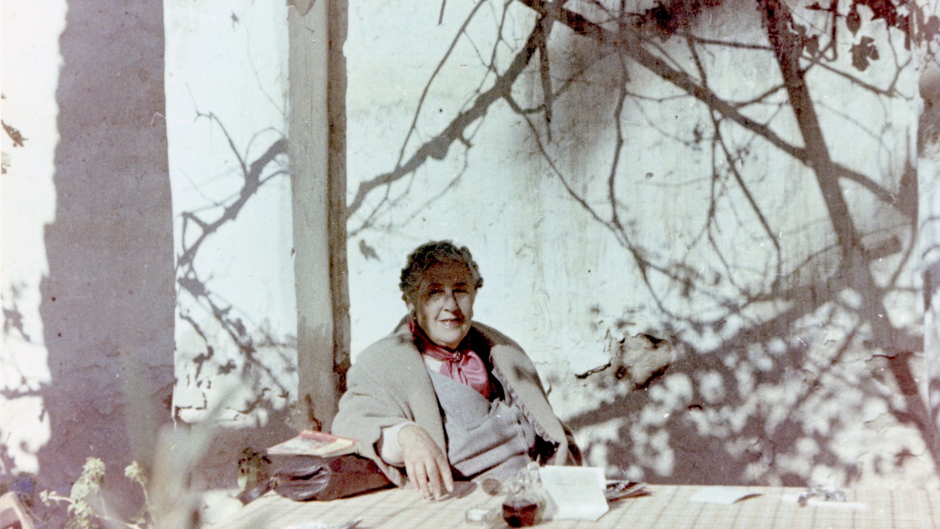 Agatha Christie relaxing during a sightseeing tour, Tajoura, Libya, 1955. © The Christie Archive Trust