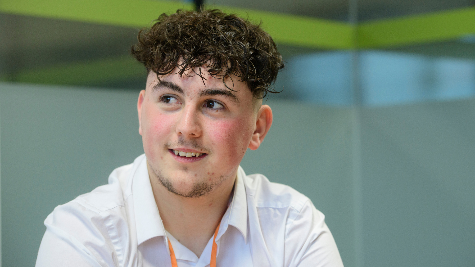 Image of Shay smiling, looking away from the camera