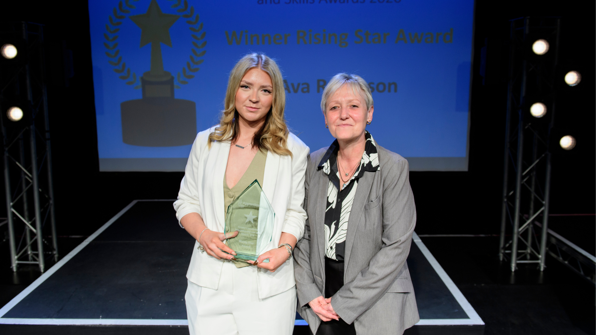 Two women posing with award