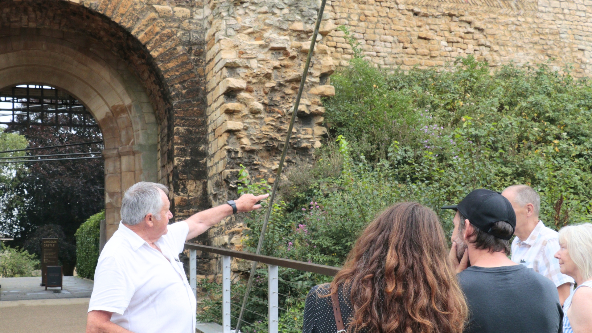 Paul Scott, a Friends of Lincoln Castle guide, points to the monument's west wall. 