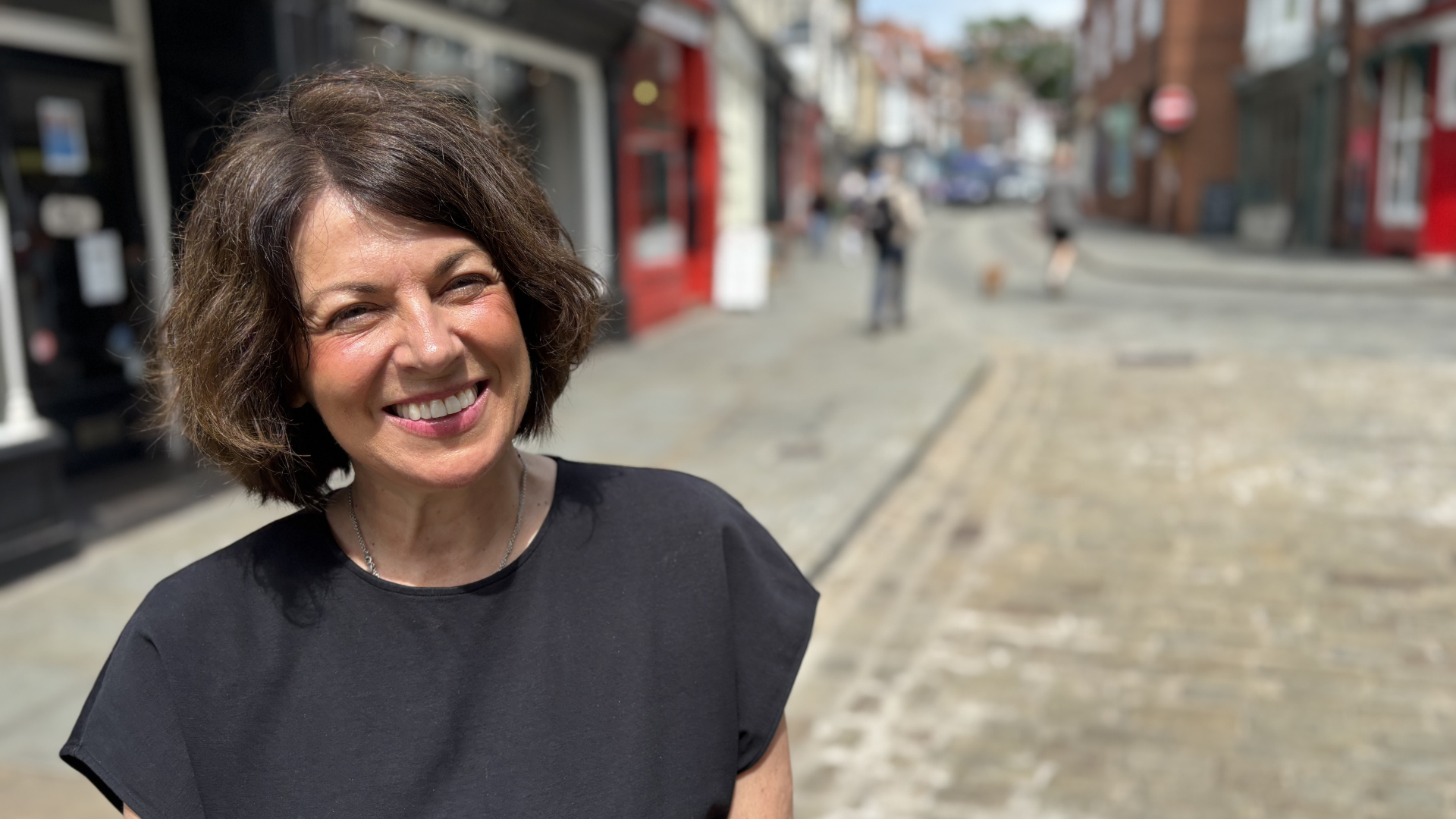 Sales assistant Faye Geoghegan standing in Lincoln's Bailgate