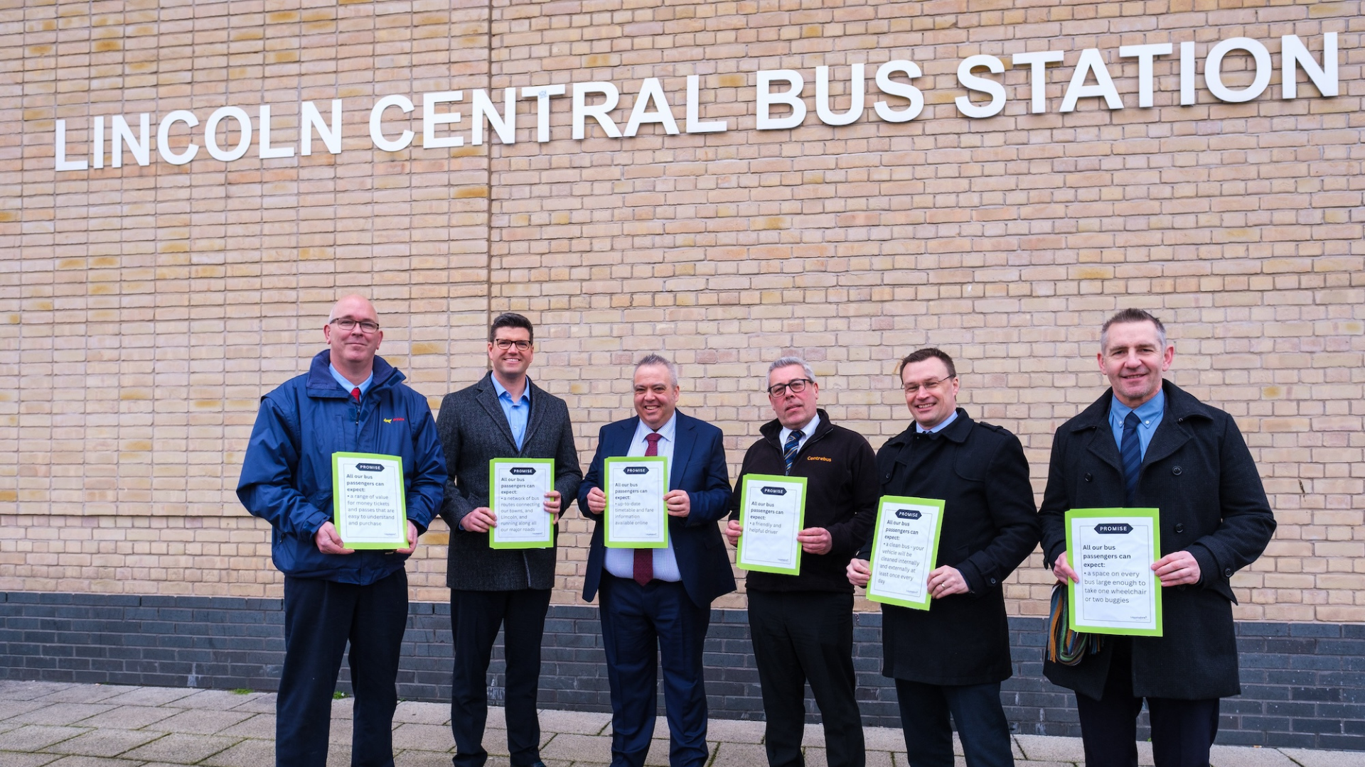 Transport bosses stand holding the charter.