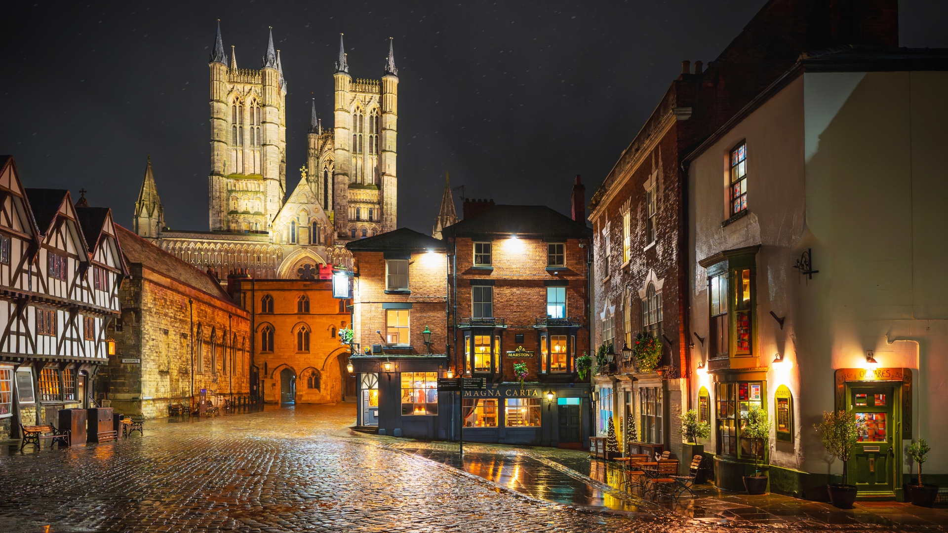 Lincoln's Castle Hill and Cathedral illuminated at night. Photography by Andrew Scott