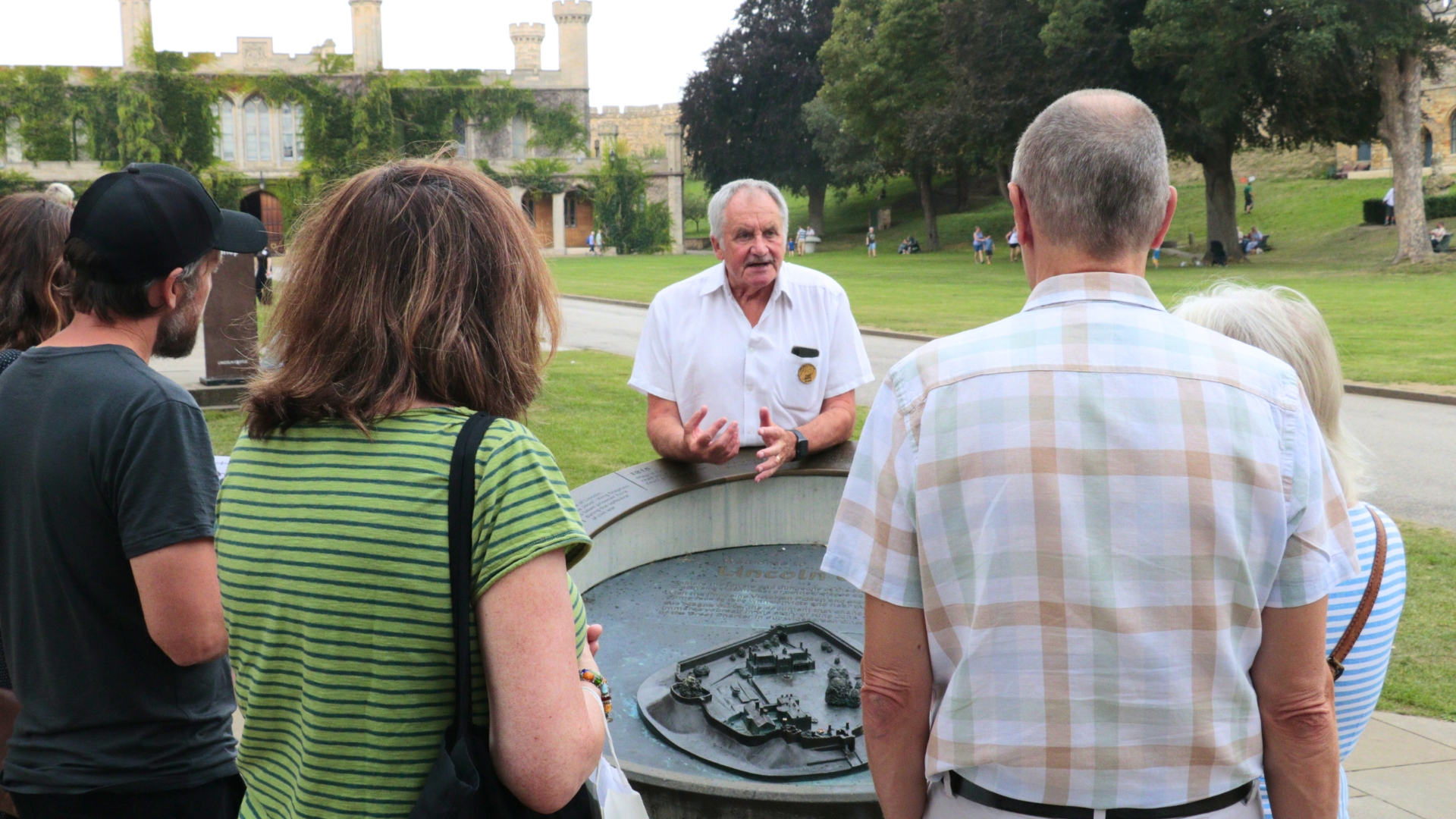 Volunteer guide, Paul Scott, addresses a group in the grounds of Lincoln Castle