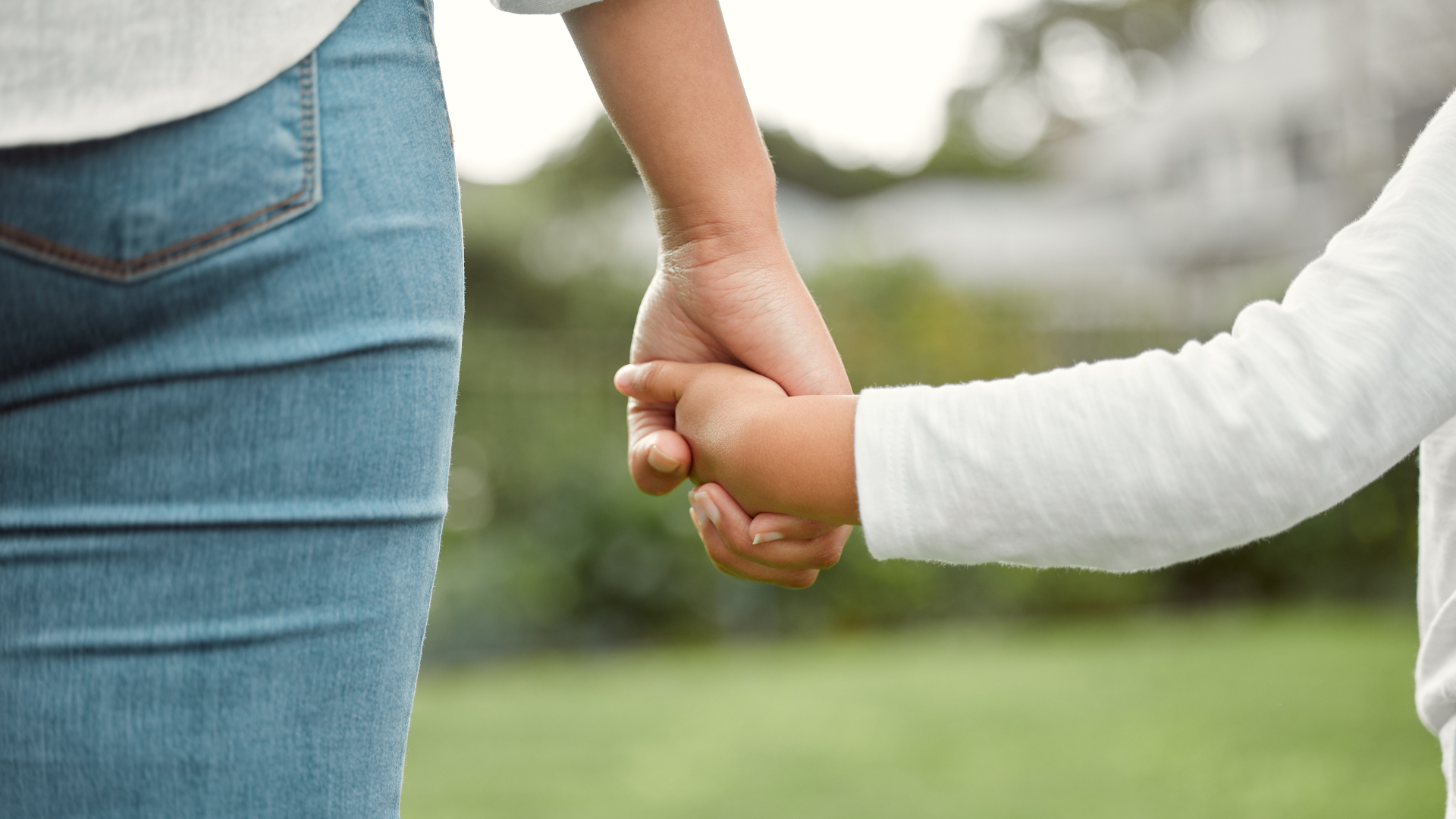 Little girl holding a woman's hand