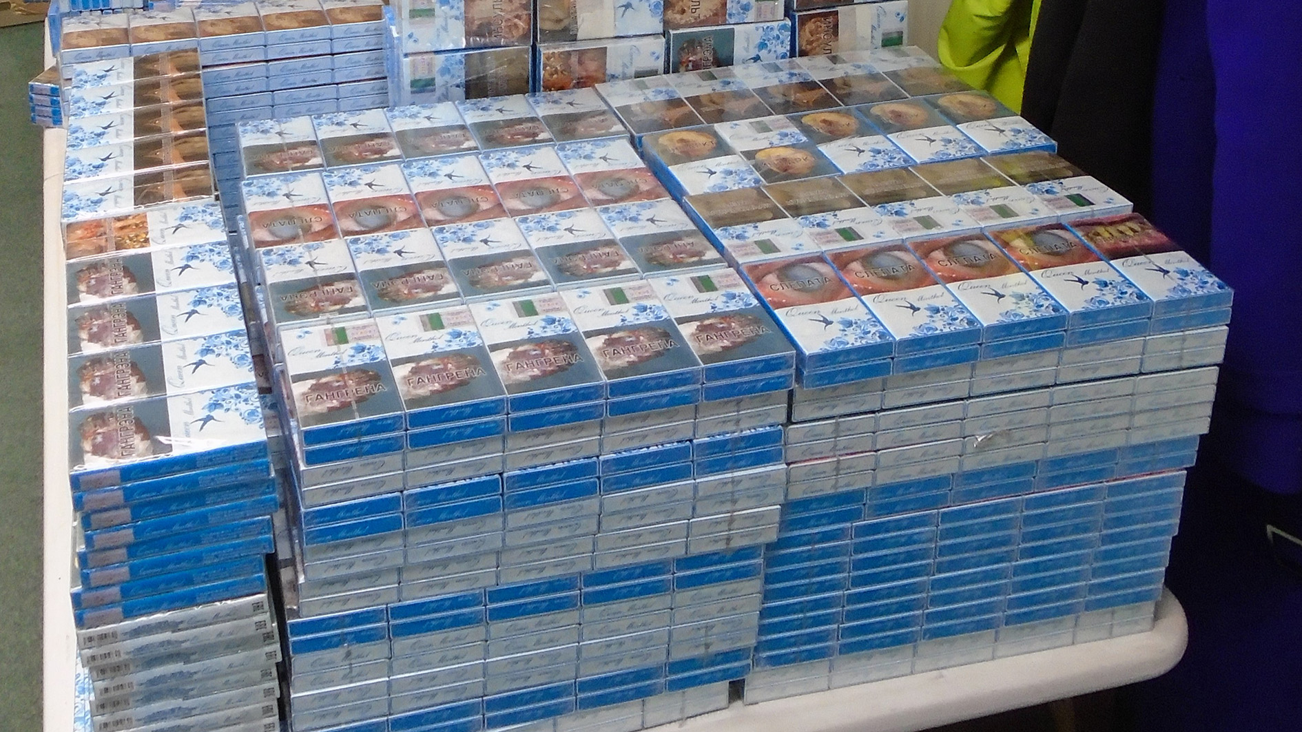 A table piled high with over 70,000 illegal cigarettes