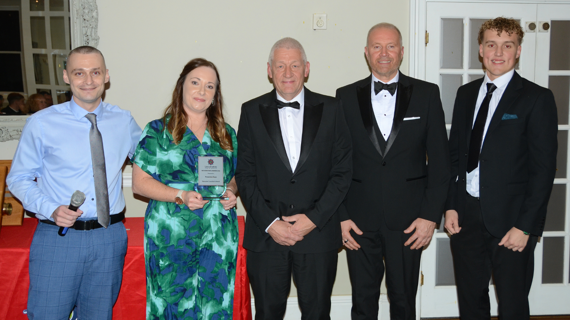 Several people posing with award