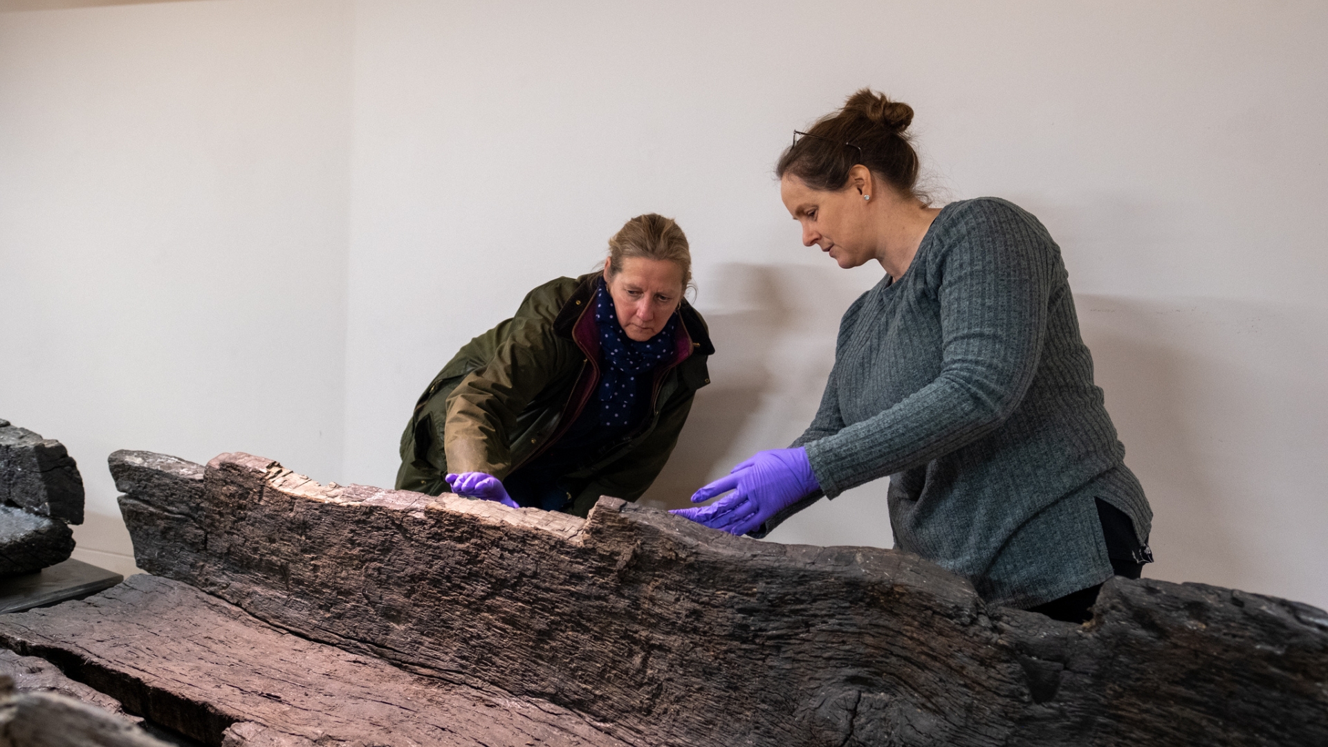 Cllr Lindsey Cawrey, executive councillor for culture at Lincolnshire County Council investigates an Iron Age boat with preservation officer, Michelle Johns