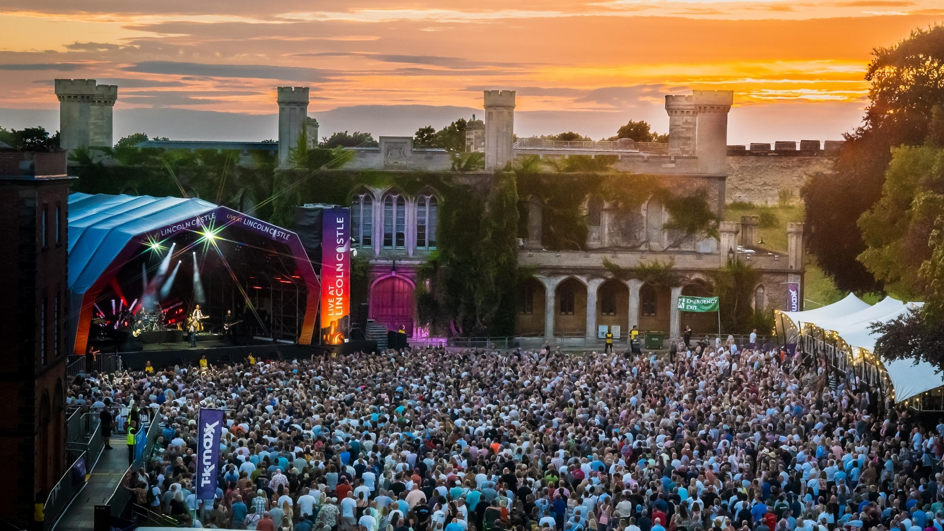 Concert goers enjoy Simple Minds' performance at Lincoln Castle in the setting sun