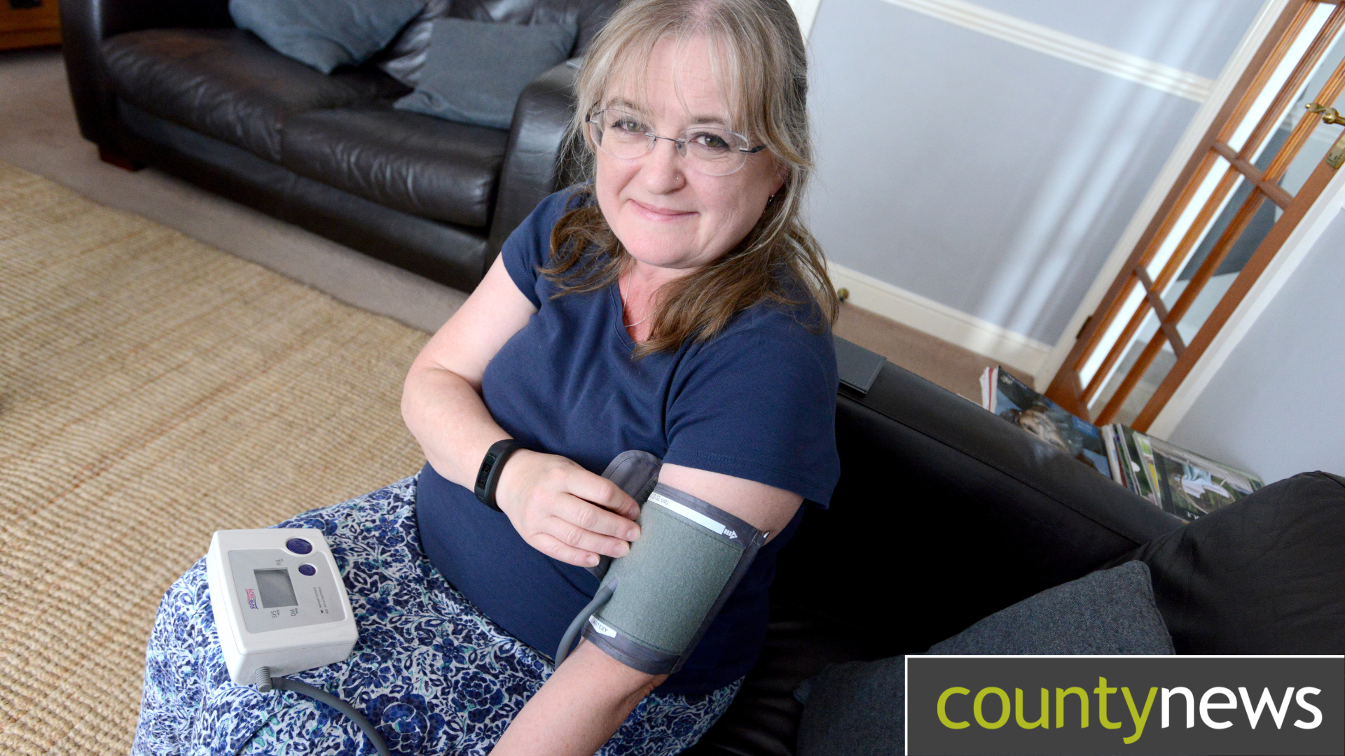Woman measuring her own blood pressure on her arm