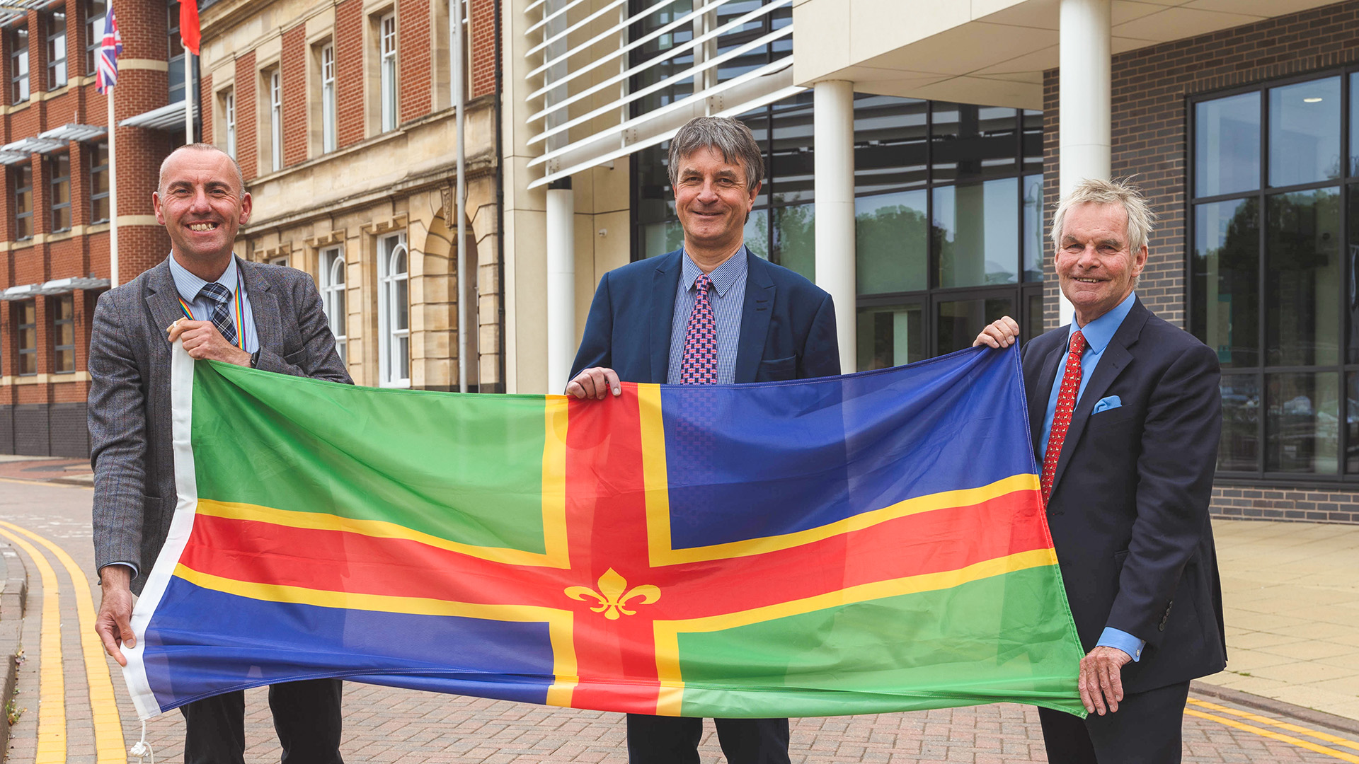 Council leaders with lincolnshire flag