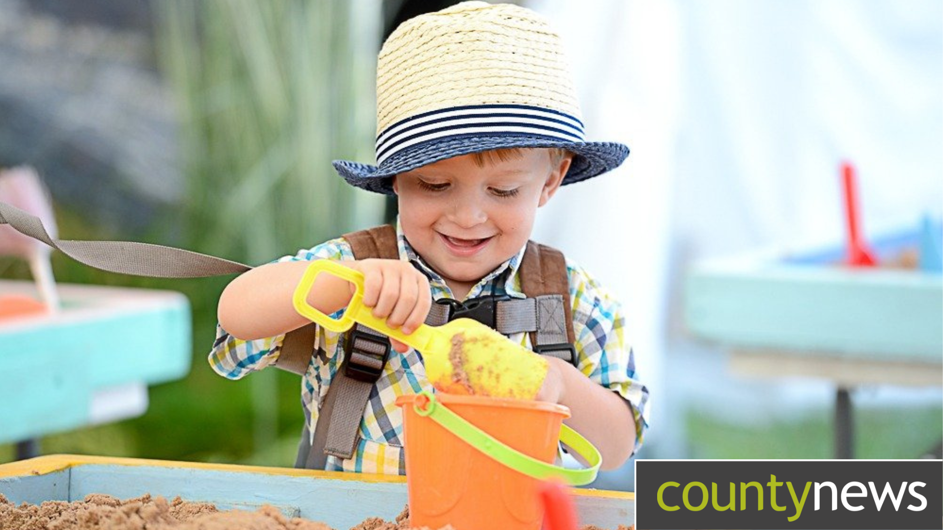 A child builds a sandcastle at the Lincolnshire County Council stand