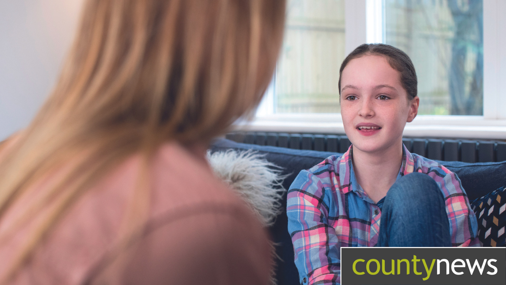 A child sits and talks with an adult