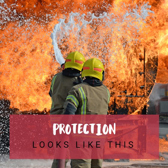 Two firefighters tackle a burning blaze, some text has been overlayed on the image which reads "Protection looks like this".