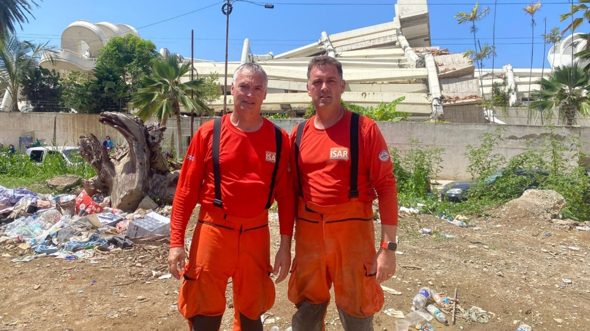 Two firefighters stand together in Venezuela
