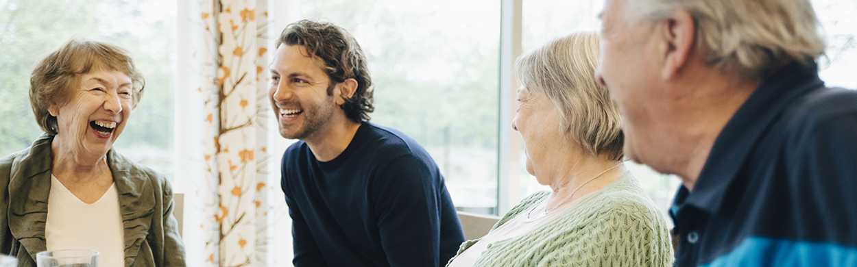 Image of a man and three elderly people laughing