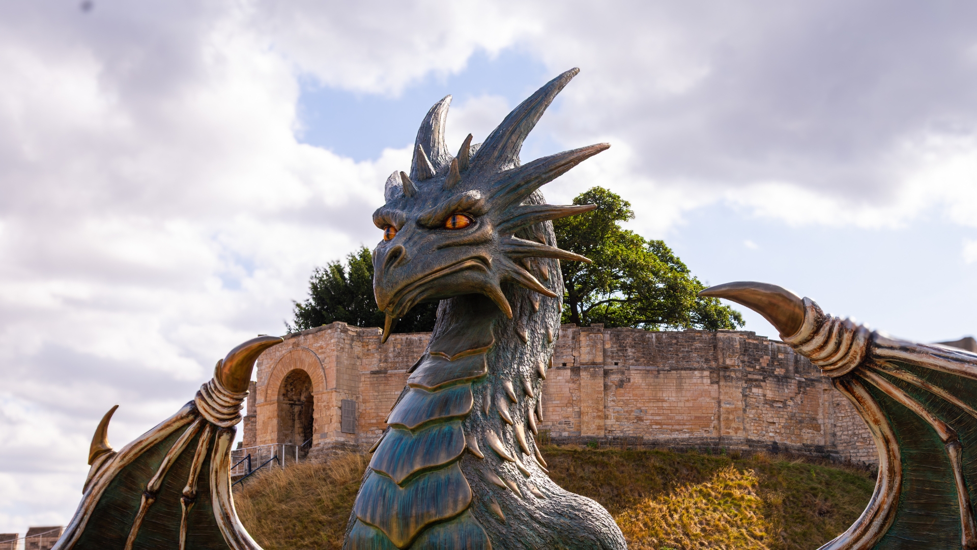 Hastings, a giant scaly dragon, is pictured in front of Lucy Tower at Lincoln Castle