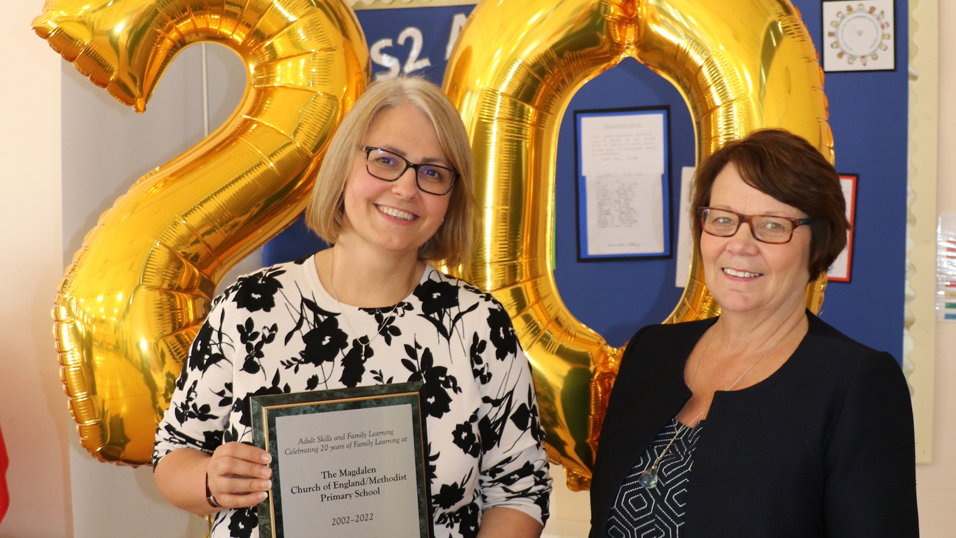 Head of school Melanie Page receives the school plaque from Cllr Wendy Bowkett