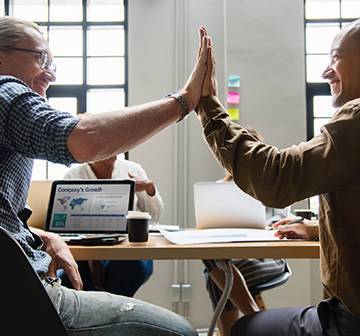 Image of two men doing a high-five