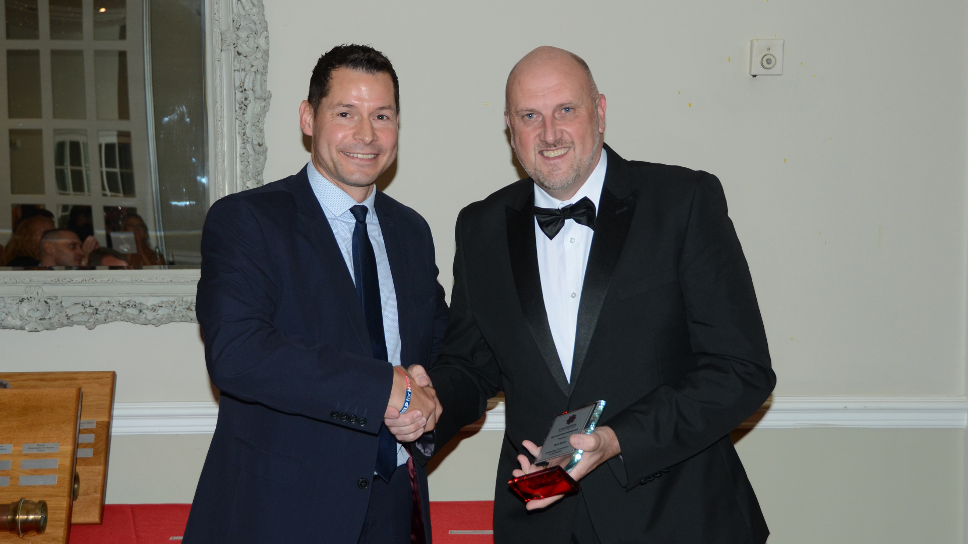 two men posing with award