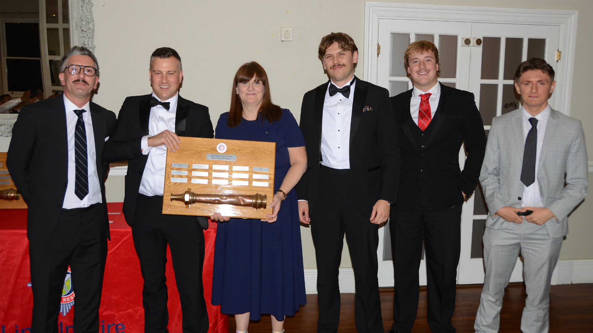 Several people posing with award