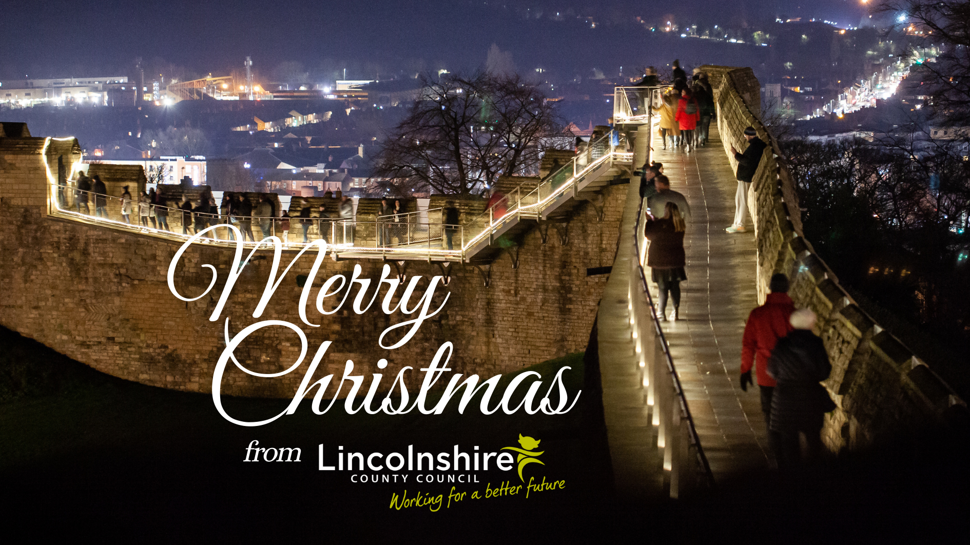 An image of the Lincoln Castle wall walk, at night time and lit up for Christmas