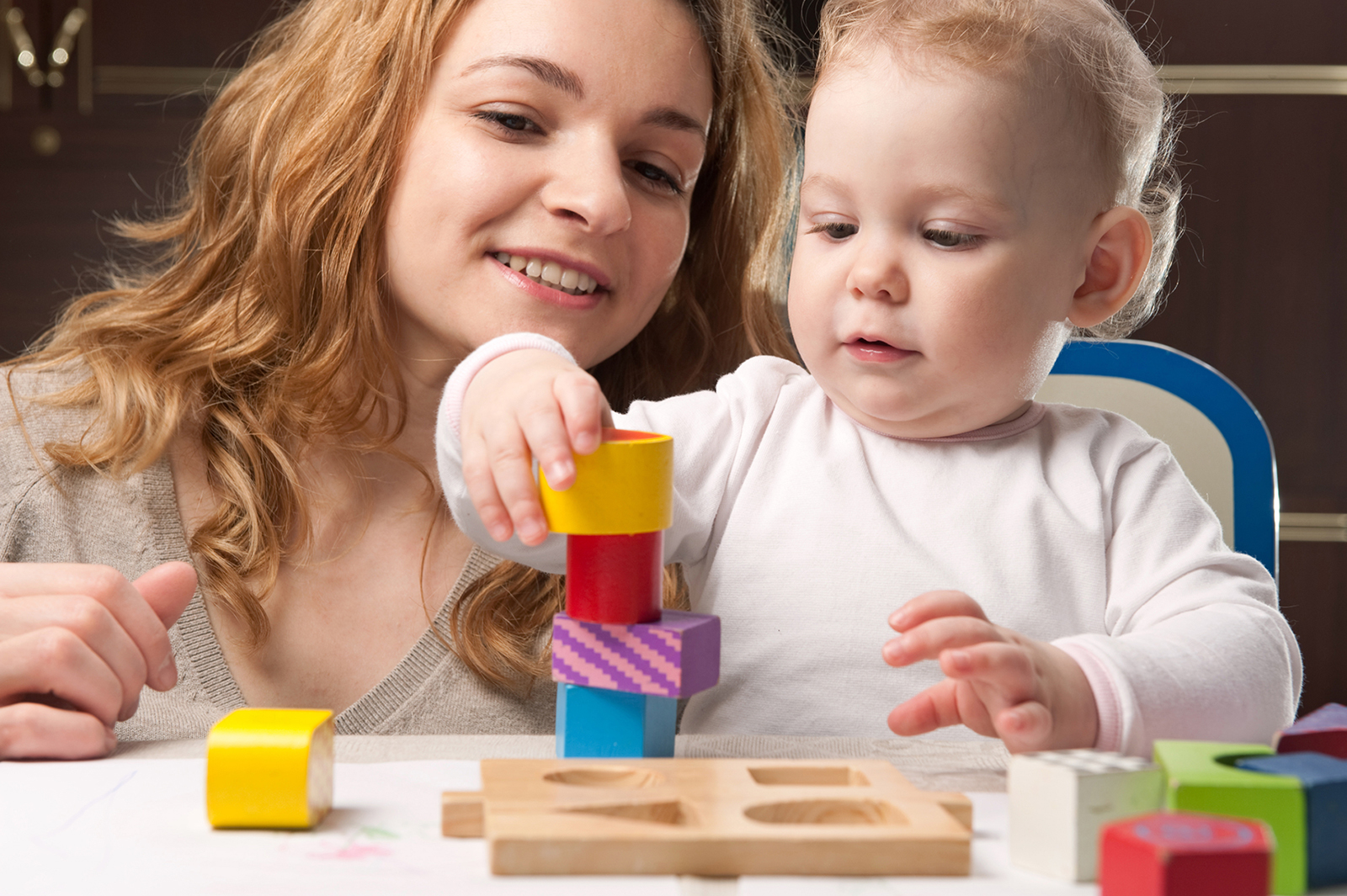 A young mother and a baby playing