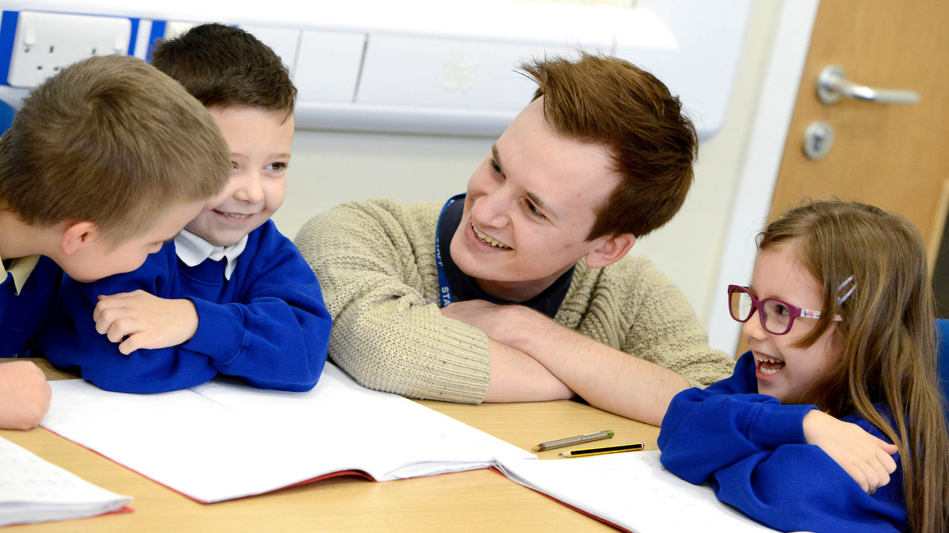 An apprentice teacher works with children in a classroom