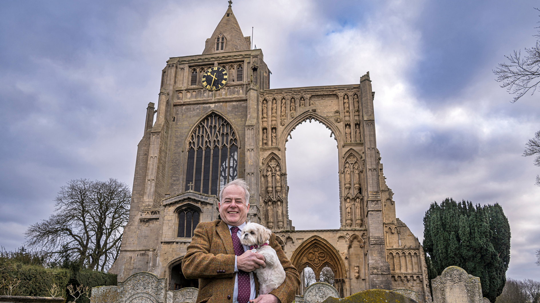 Cllr Nigel Pepper stands in front of Crowland Abbey