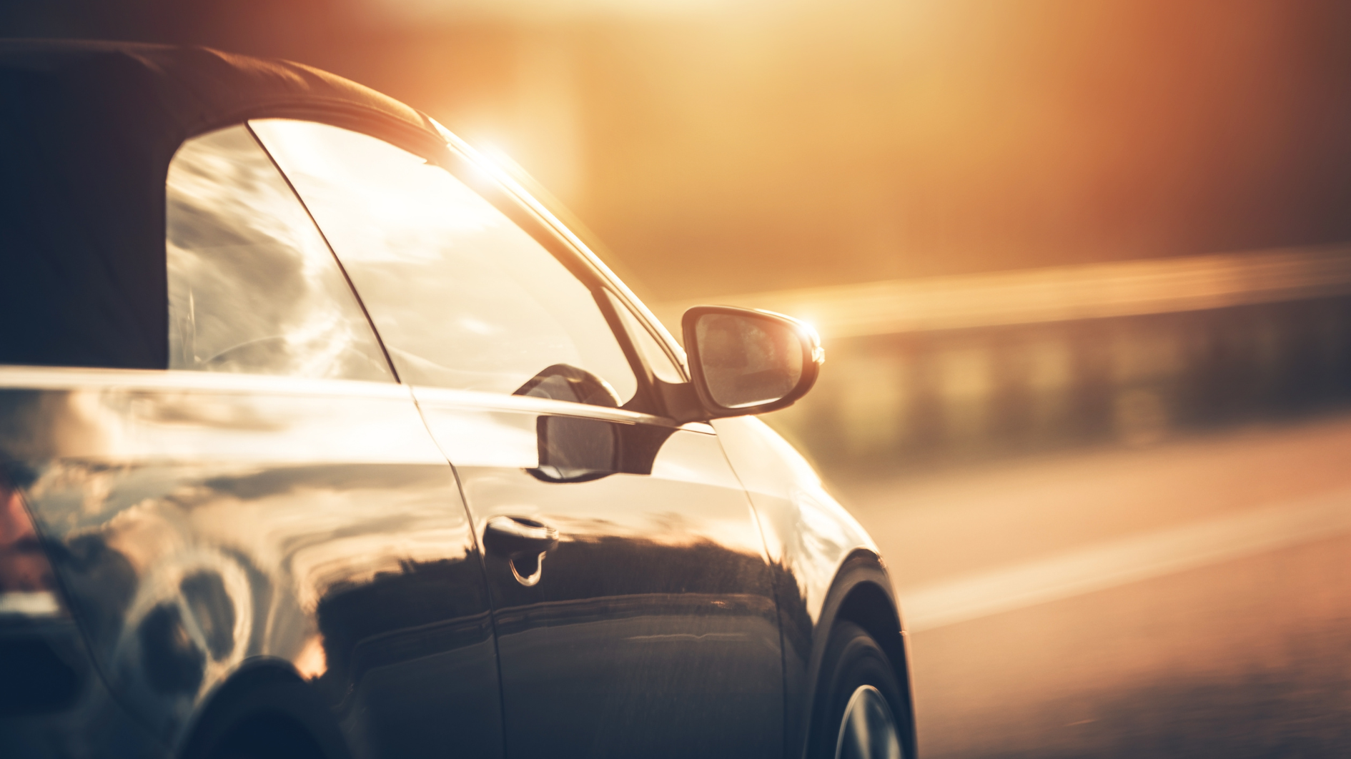 Car driving down road in summer heat