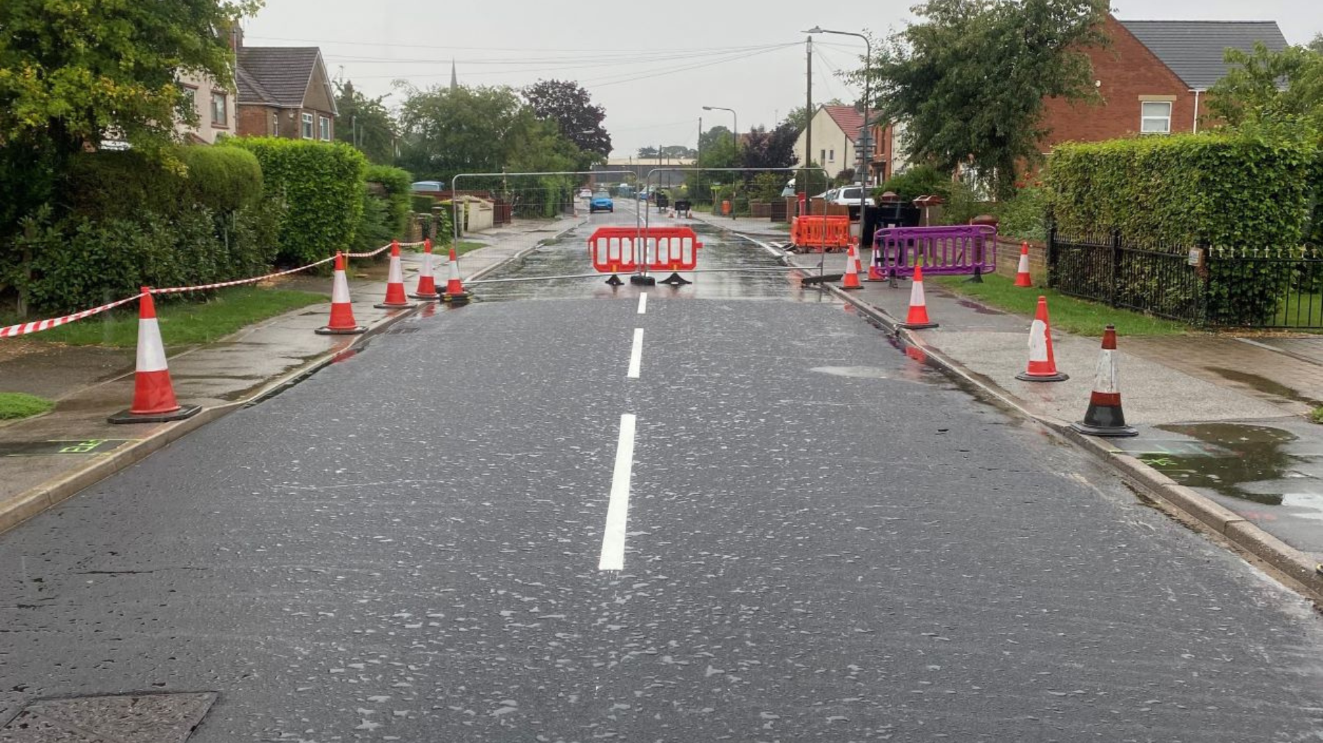 Road with white markings and cones running along the edges