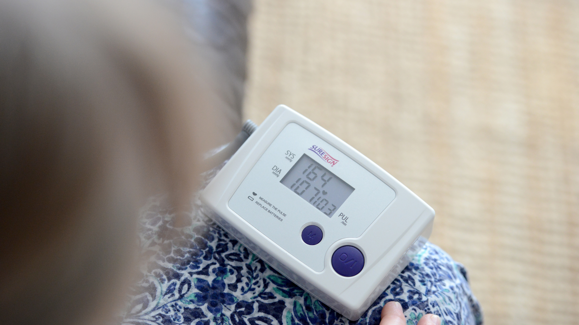 A woman using blood pressure monitor