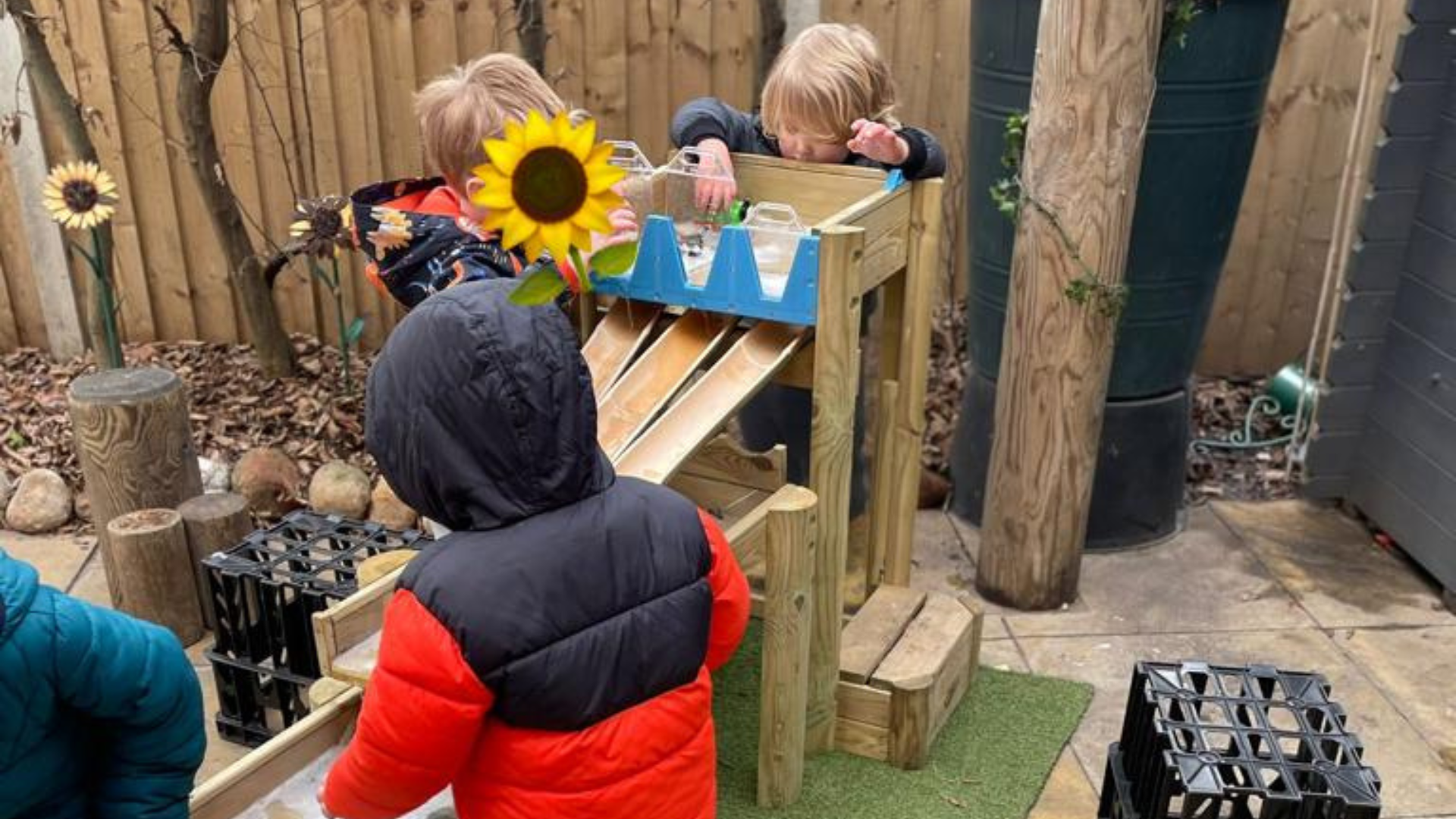 Four children play on a water table