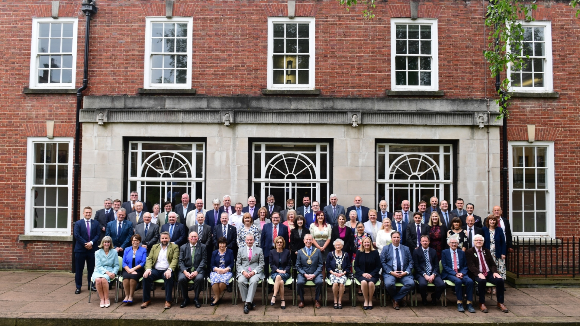 Councillors sat outside a building