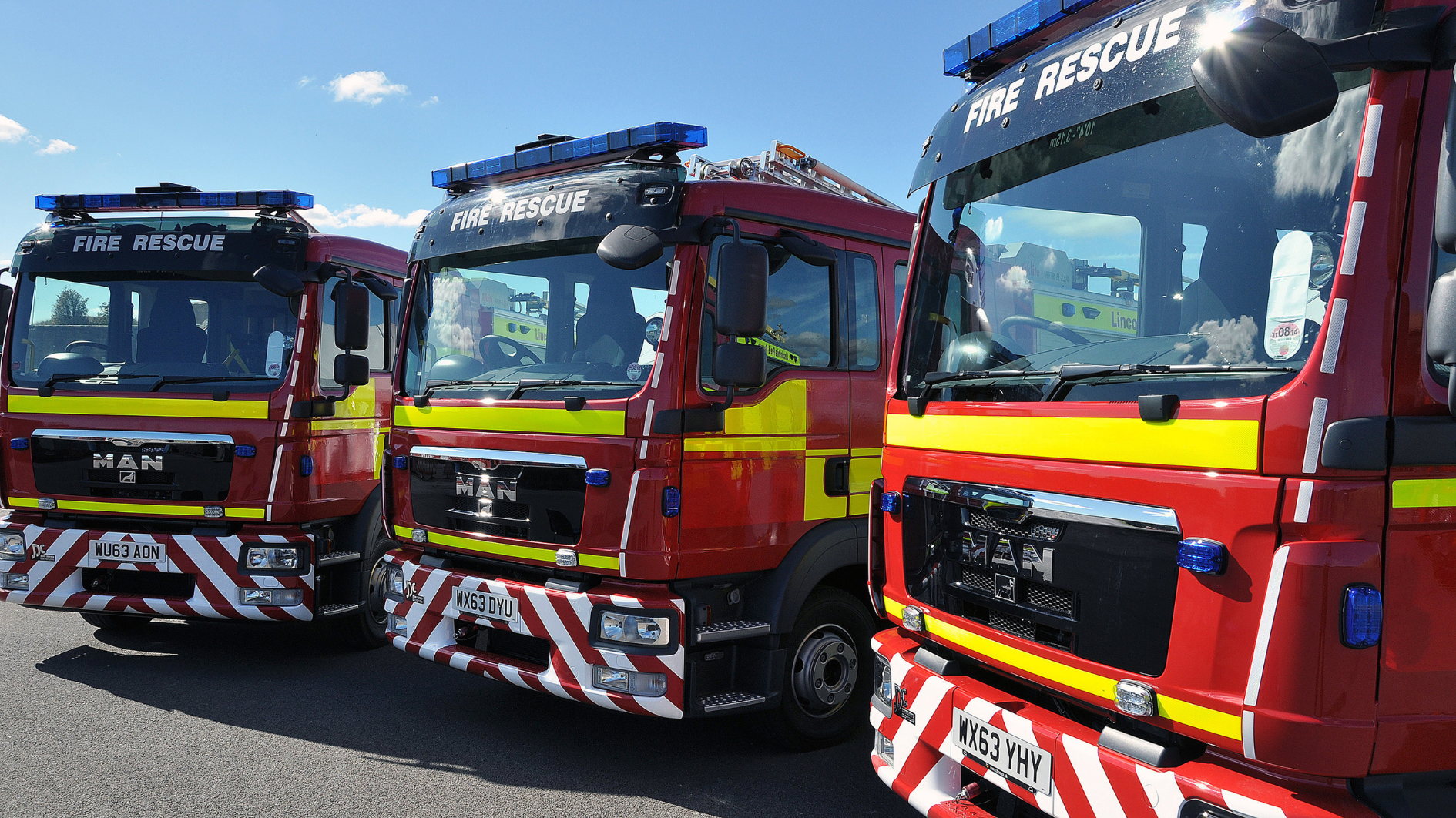 Three fire engines are parked up in a row