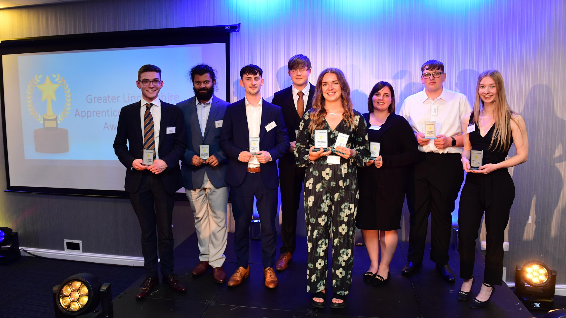 Apprenticeship champions 2024

Young people standing in stage lights holding awards