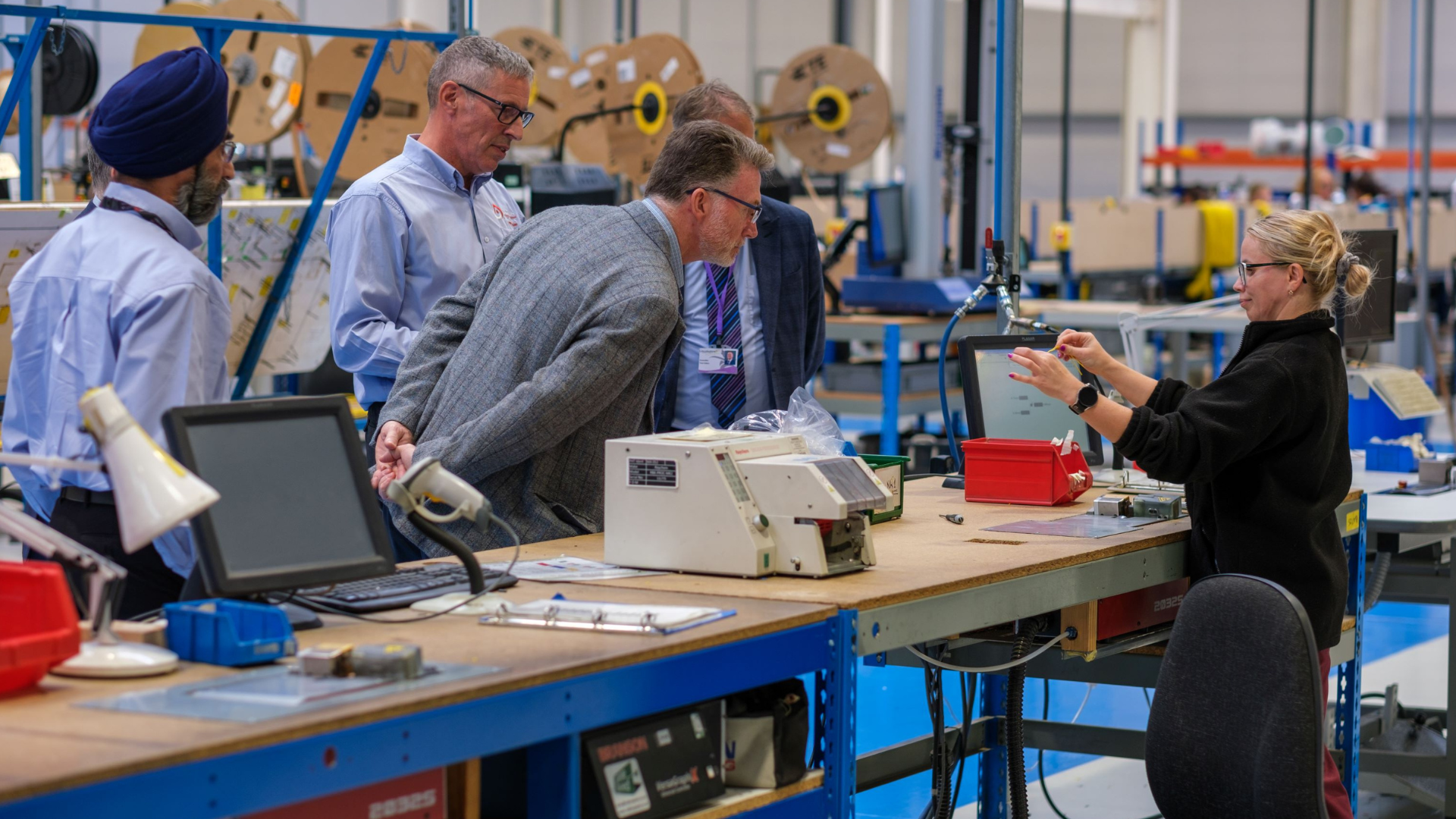 Councillors being shown cable by workshop worker