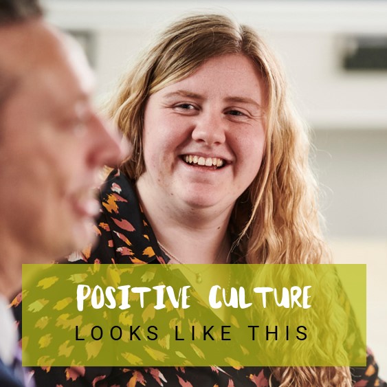 A women smiling with text reading &#039;positive culture looks like this&#039;