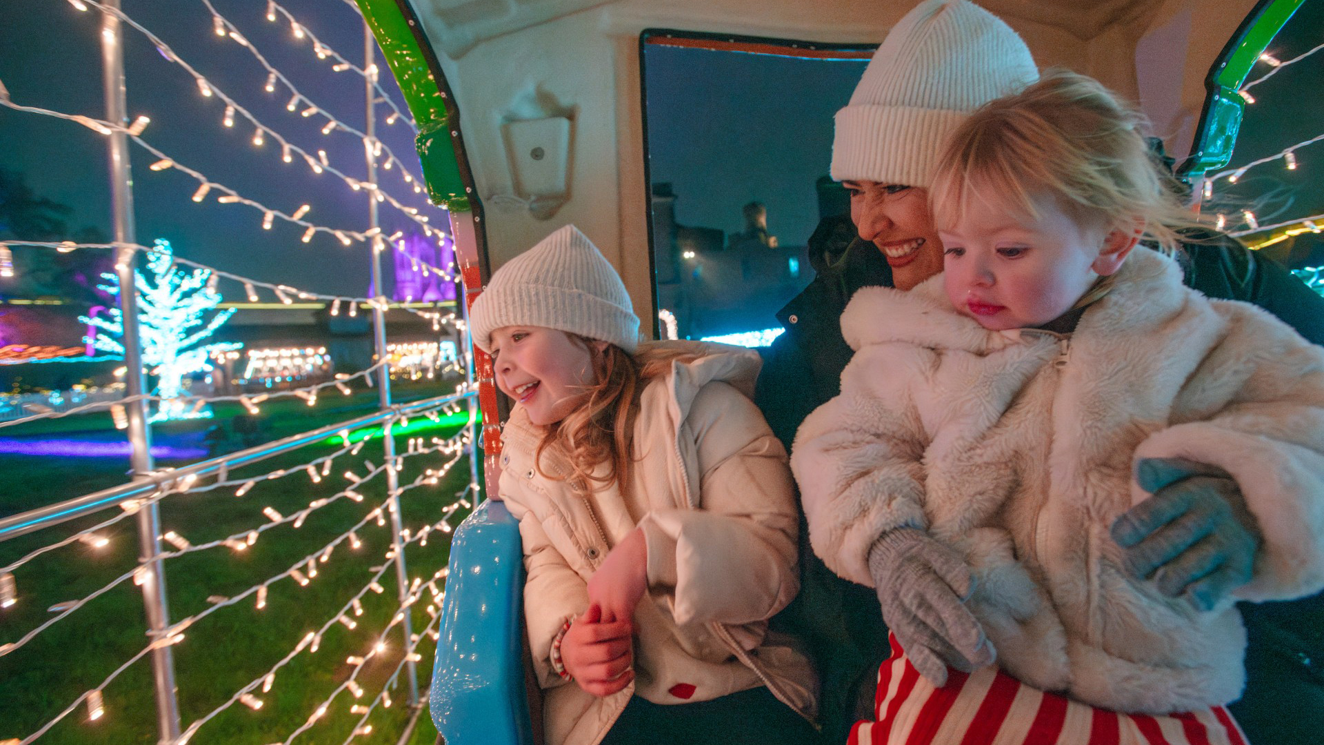 Image of mother and children enjoying Lincoln Castle Illuminated.