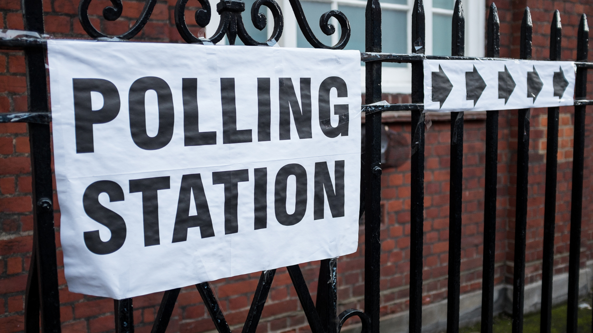 Polling station signs on a railing
