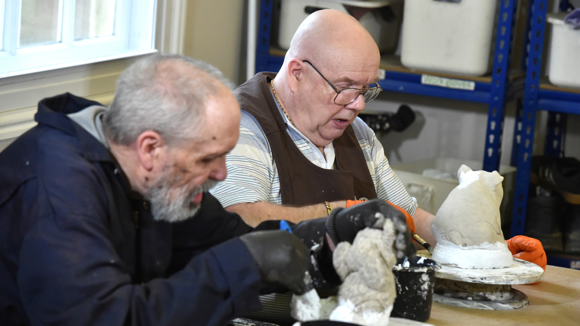 Richard Parish and Mick Robinson enjoy the task of painting the new garden figures.